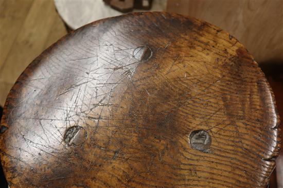 An 18th century elm primitive stool W.40cm at base